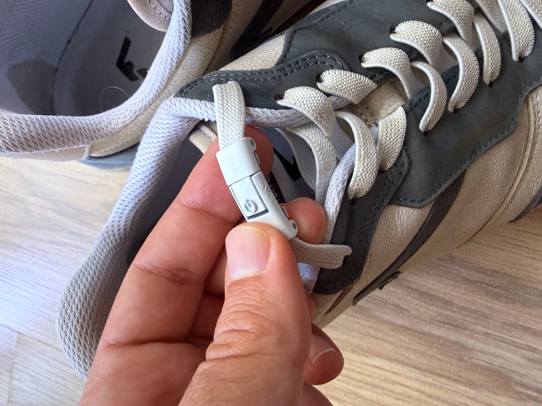 Close-up of an aftermarket elastic no-tie lace and clip installed on a WYDE Nova